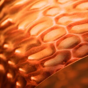 Macro close-up of a softly glowing lamp surface and material texture, for Bloomind detail shot.